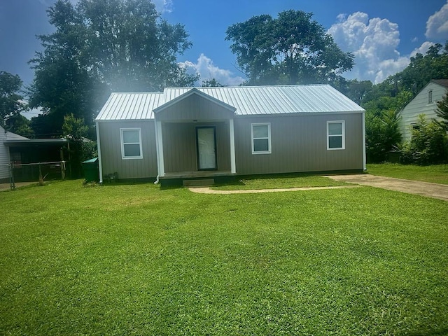  - view of front of property featuring a front yard and a metal roof