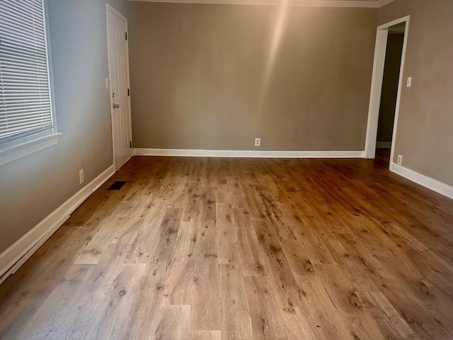  - unfurnished room with wood finished floors and baseboards
