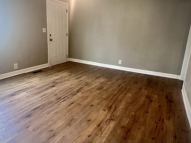  - unfurnished room with baseboards and dark wood finished floors