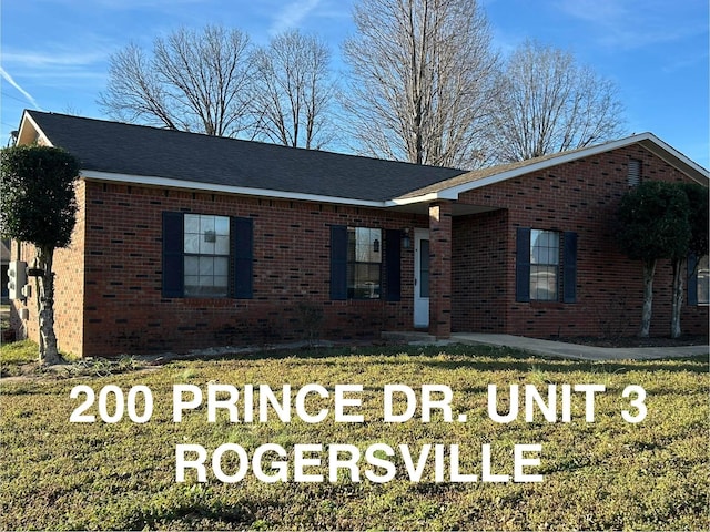 ranch-style house featuring brick siding, a front lawn, and roof with shingles