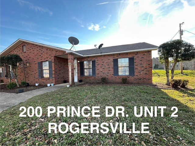 ranch-style house featuring brick siding and a front lawn