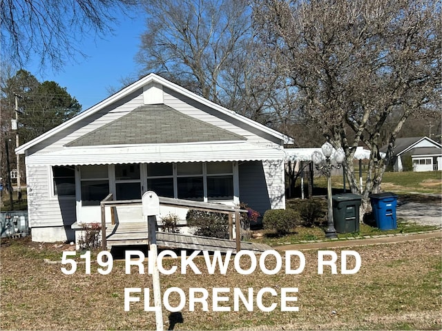 view of front of house featuring roof with shingles