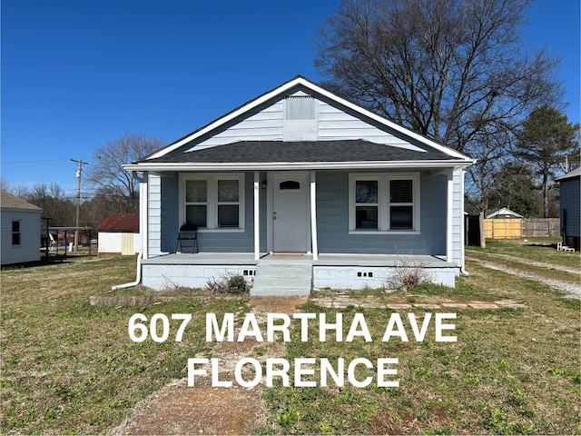 bungalow-style home with a porch, a front yard, crawl space, and a shingled roof