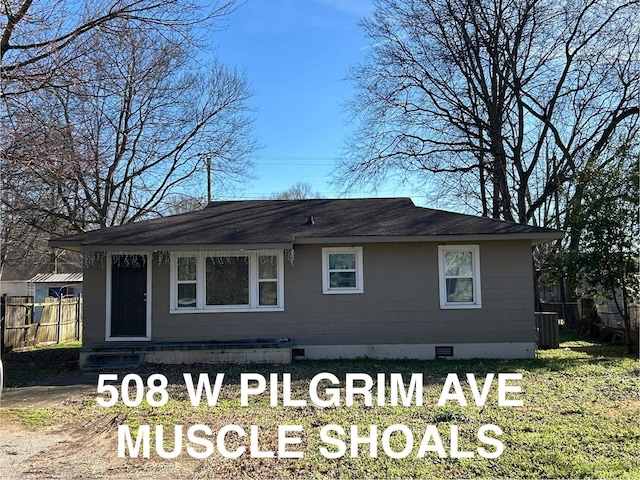 view of side of home featuring crawl space, cooling unit, and fence