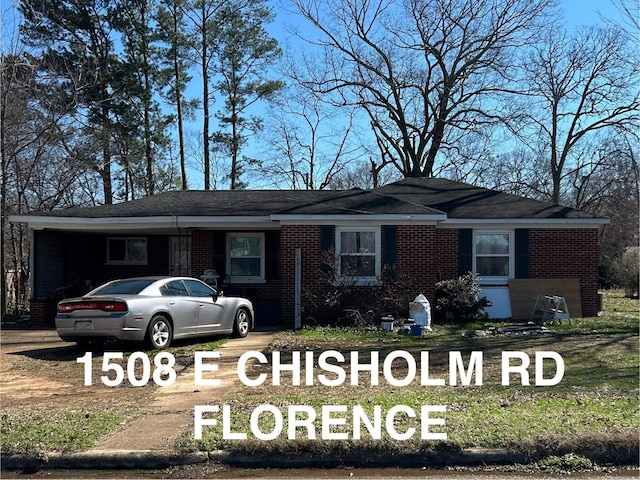 view of front of home featuring a carport and brick siding