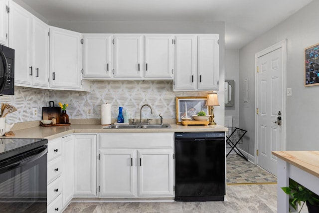 kitchen with white cabinets, a sink, and black appliances