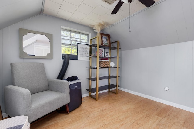 living area featuring ceiling fan, baseboards, wood finished floors, and lofted ceiling