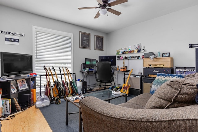 living area with wood finished floors and ceiling fan