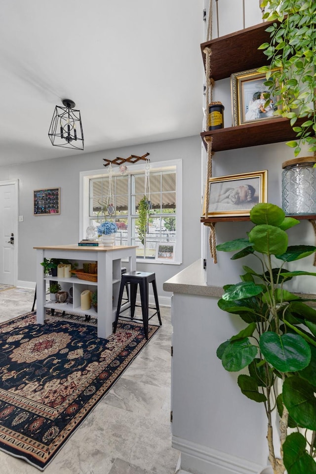 dining area with baseboards and marble finish floor