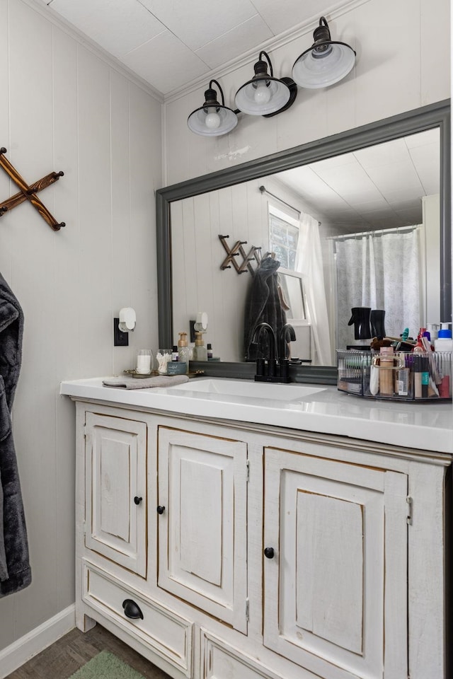 full bathroom featuring crown molding and vanity
