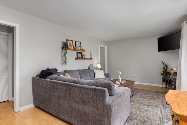 living area featuring light wood-type flooring and baseboards