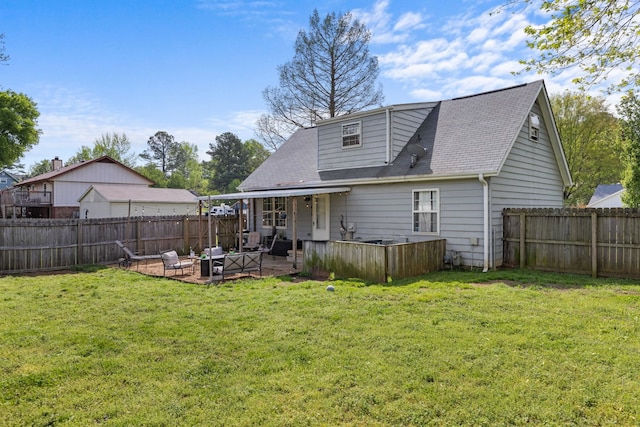 back of house featuring a fenced backyard, a shingled roof, a patio, and a lawn