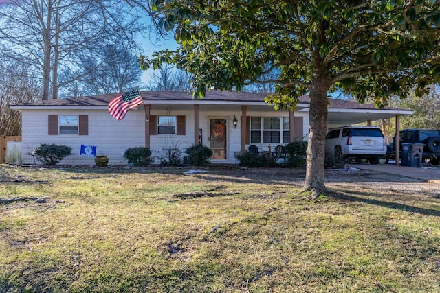 ranch-style home featuring a front yard, a porch, and a carport