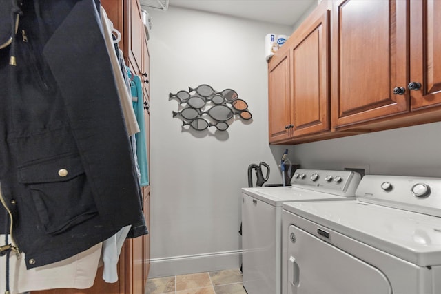  - washroom with washer and dryer, cabinet space, and baseboards