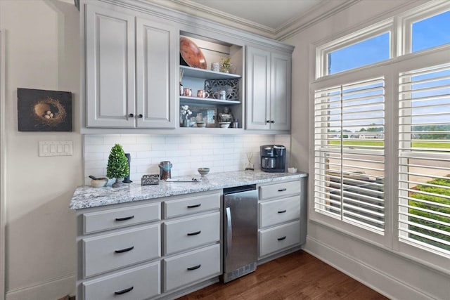  - bar area featuring backsplash, crown molding, fridge, dark wood-type flooring, and baseboards