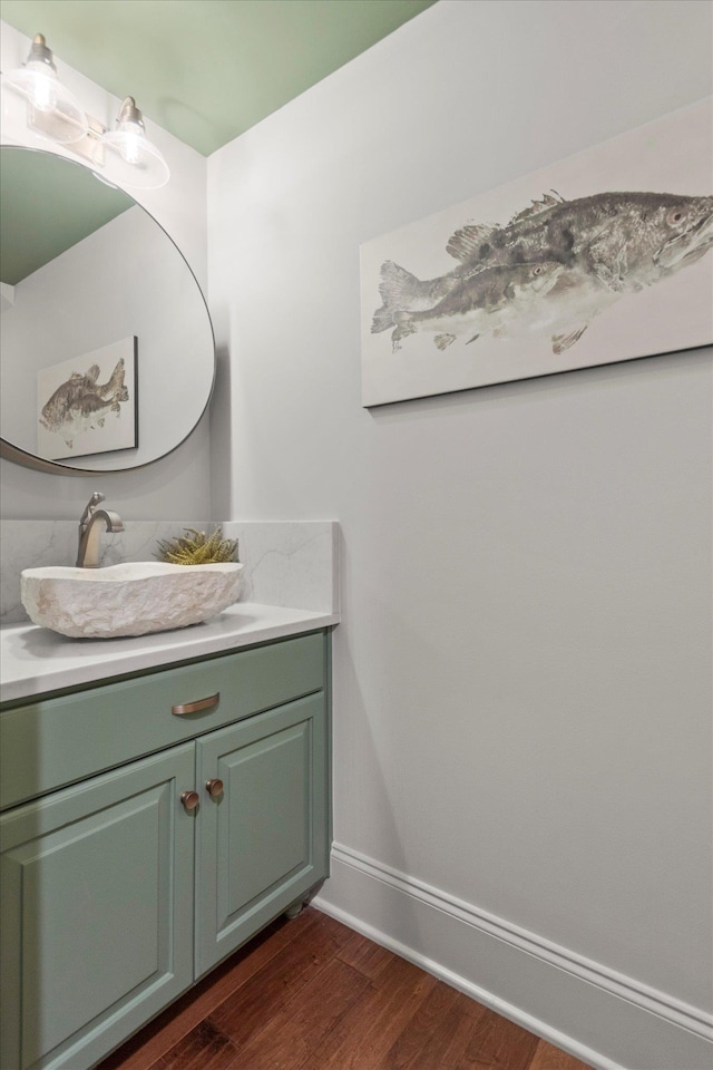  - bathroom featuring wood finished floors, baseboards, and vanity