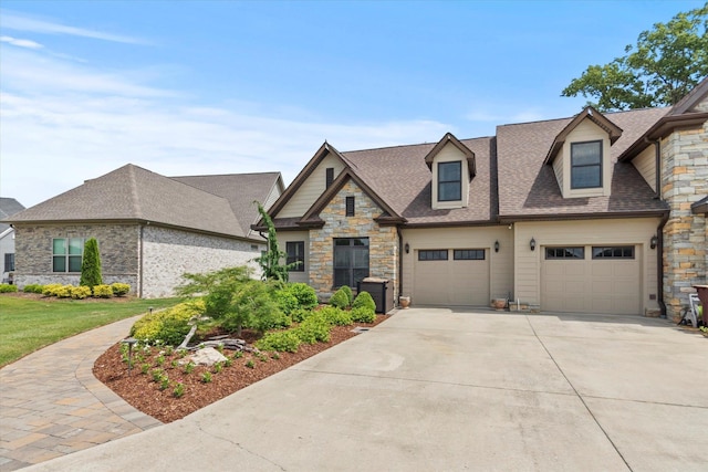  - craftsman-style home featuring concrete driveway, stone siding, a shingled roof, and an attached garage