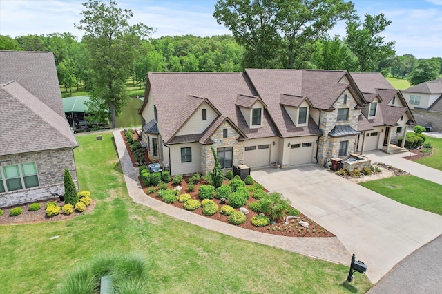  - view of front facade with stone siding, driveway, a garage, a front lawn, and a shingled roof
