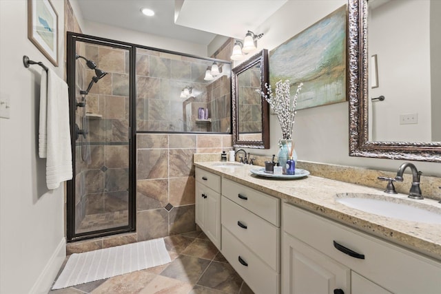  - bathroom with a shower stall, double vanity, tile patterned flooring, and recessed lighting