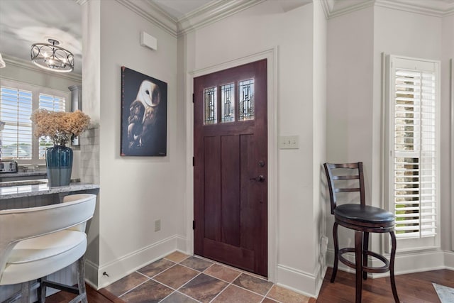  - foyer with baseboards and ornamental molding