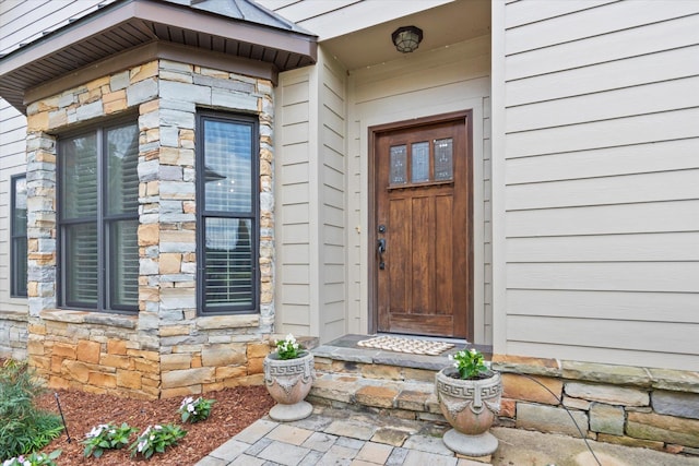  - doorway to property with stone siding