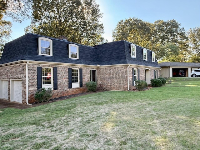 view of front facade with a garage and a front lawn