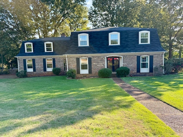 new england style home with a front yard and french doors