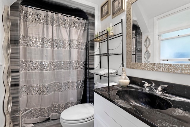  - bathroom with vanity, toilet, and curtained shower
