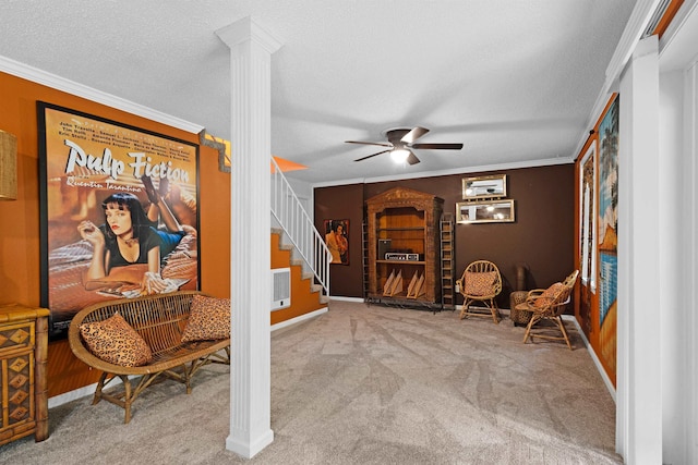  - sitting room featuring ceiling fan, carpet flooring, crown molding, ornate columns, and baseboards