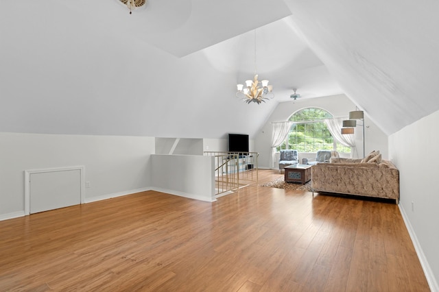  - bonus room featuring vaulted ceiling, light wood-type flooring, a chandelier, and baseboards