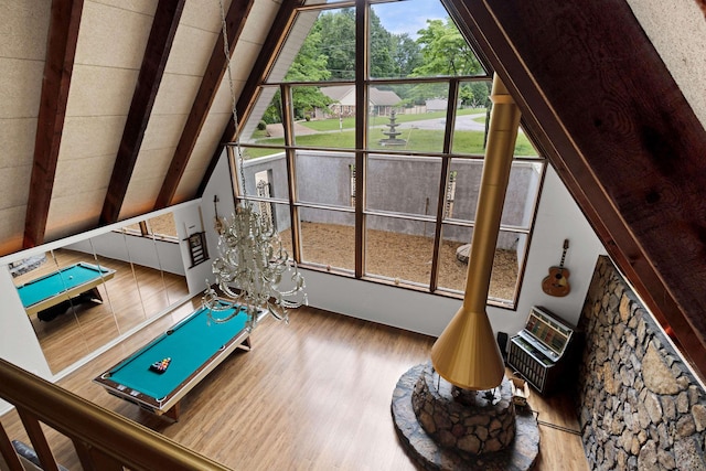  - exercise room featuring lofted ceiling and wood finished floors