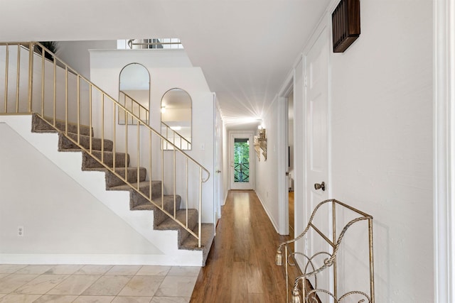  - staircase featuring baseboards