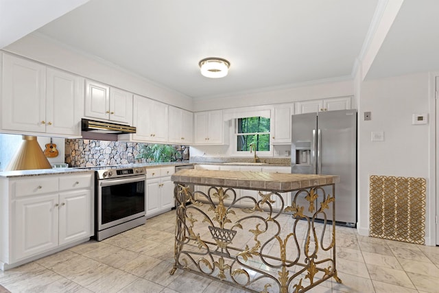  - kitchen with appliances with stainless steel finishes, under cabinet range hood, a sink, ornamental molding, and white cabinets
