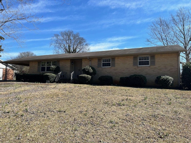 single story home with an attached carport and brick siding