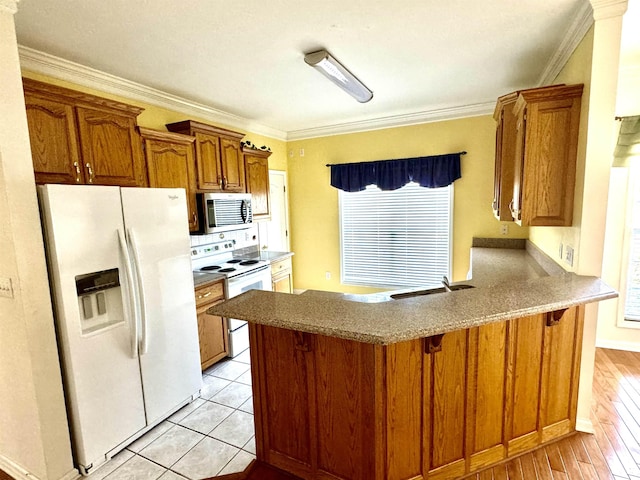 kitchen featuring kitchen peninsula, sink, white appliances, and ornamental molding