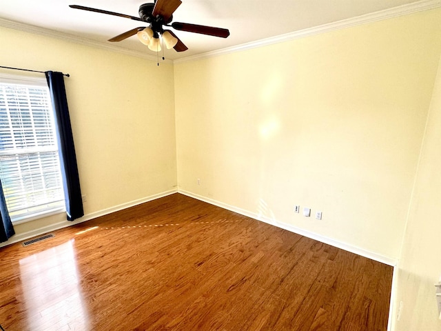 unfurnished room featuring plenty of natural light, ceiling fan, wood-type flooring, and crown molding