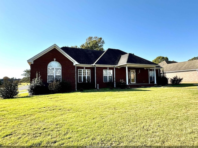 single story home featuring a front lawn