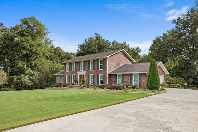 colonial inspired home with a front yard