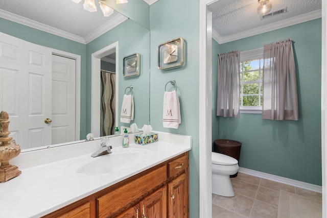 bathroom featuring vanity, tile patterned flooring, toilet, ornamental molding, and a textured ceiling