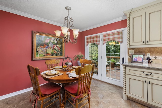 dining area with a notable chandelier, ornamental molding, and a textured ceiling