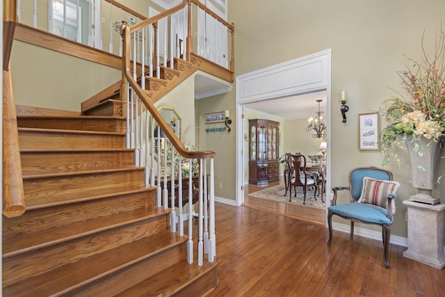 entryway with hardwood / wood-style flooring and a notable chandelier