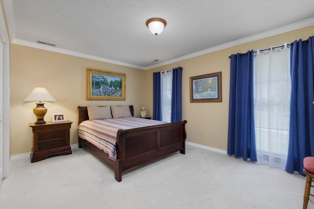 carpeted bedroom with a textured ceiling and crown molding