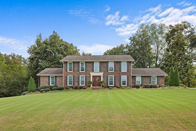 colonial-style house with a front lawn