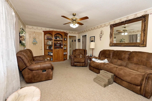 living room featuring ceiling fan, light colored carpet, a textured ceiling, and ornamental molding