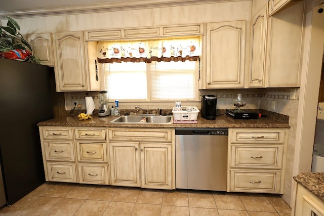 kitchen featuring decorative backsplash, black refrigerator, sink, light tile patterned floors, and dishwasher