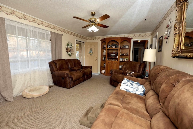 carpeted living room with ceiling fan and a textured ceiling