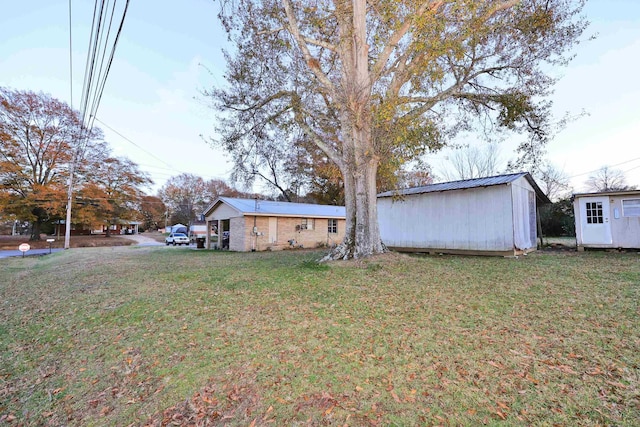 exterior space featuring a front lawn and a storage unit