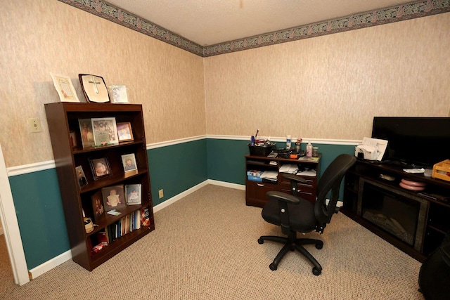 carpeted home office with a textured ceiling