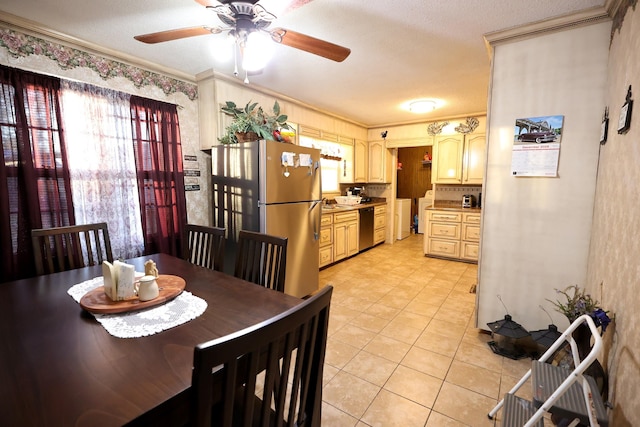 tiled dining area featuring ceiling fan and ornamental molding