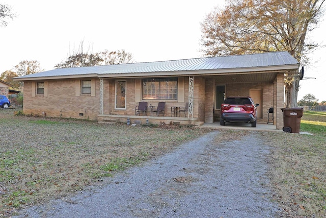 ranch-style home featuring a carport and a porch